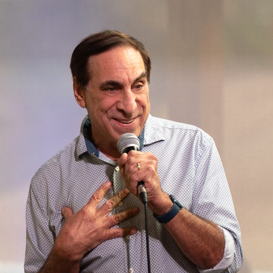 Walter Gottlieb performing stand-up with a microphone.
